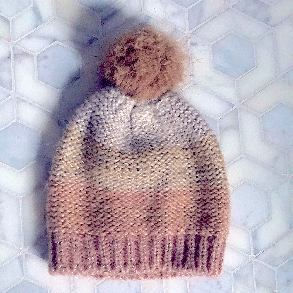 Striped winter hat in tan and pink hues
